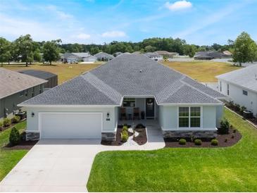 Beautiful single-story home with a well-manicured lawn and attached two-car garage at 4743 Nw 11Th Ct, Ocala, FL 34475