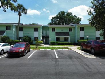 Inviting two-story condo building featuring well-maintained landscaping and convenient parking at 606 Midway Dr # B, Ocala, FL 34472