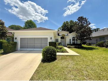 Charming single-story home with a well-maintained lawn and an attached two-car garage at 6836 Sw 112Th St, Ocala, FL 34476
