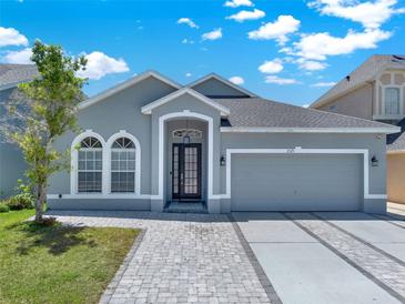 Charming single-story home features a two-car garage and lovely landscaping at 2525 Sand Arbor Cir, Orlando, FL 32824