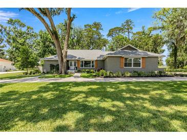 Charming one-story home boasts professional landscaping, newer paint, and updated shutters, enhancing its curb appeal at 5326 Nw 76Th Ct, Ocala, FL 34482