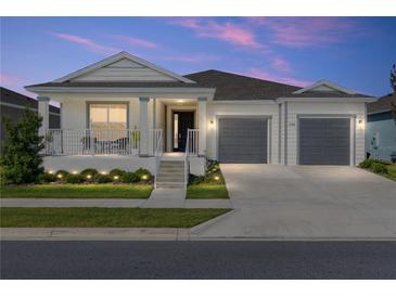 Charming single-story home featuring a welcoming front porch and two-car garage at 6342 Sw 77Th Ave, Ocala, FL 34474