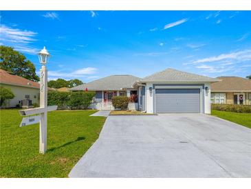 Charming single Gathering home featuring a spacious driveway and well-manicured front yard at 6758 Sw 114Th Street Rd, Ocala, FL 34476