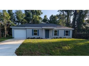 Charming single-story home with a well-maintained lawn and a classic, inviting facade at 267 Oak Lane Trak, Ocala, FL 34472
