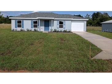 Charming single-story home featuring a well-maintained lawn and attached garage at 2803 Sw 147Th Ct, Ocala, FL 34481