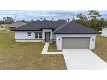 New single-story home featuring a two-car garage and a modern design in a serene neighborhood at 4415 Sw 169Th Lane Rd, Ocala, FL 34473