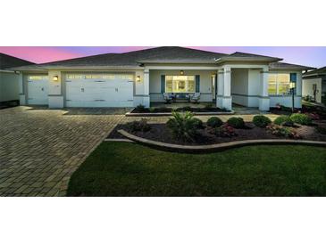 Charming single-story home with a well-manicured front yard and two-car garage at 8457 Sw 97Th Cir, Ocala, FL 34481