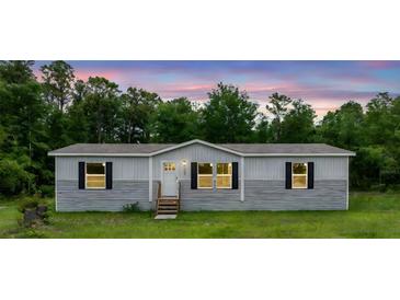 Charming single-story home featuring a well-manicured lawn and inviting entrance at 16231 Sw 20Th Ln, Ocala, FL 34481
