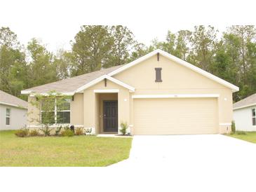 Charming single-story home with a two-car garage, neutral tones, and a well-maintained lawn at 356 Se 66Th Ct, Ocala, FL 34472