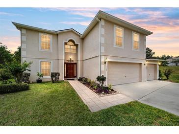 Two-story home with a two-car garage, well-manicured lawn, and inviting front entrance at 4620 Sw 42Nd St, Ocala, FL 34474
