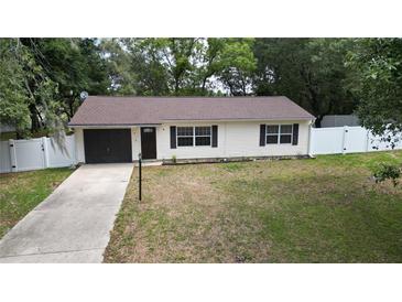 Charming single-story home with a well-maintained lawn and white picket fence at 9 Pine Radial Ct, Ocala, FL 34472