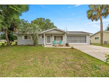 Charming single-story home featuring a well-maintained lawn and a welcoming front porch at 11091 Sw 76Th Ter, Ocala, FL 34476