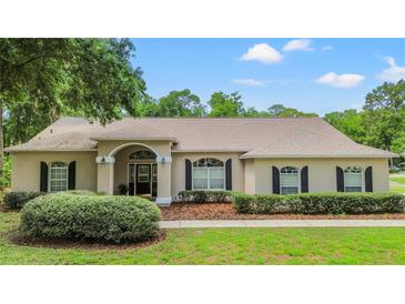 Charming single-story home with a well-manicured lawn, arched entryway, and inviting curb appeal at 1617 Se 29Th Ter, Ocala, FL 34471