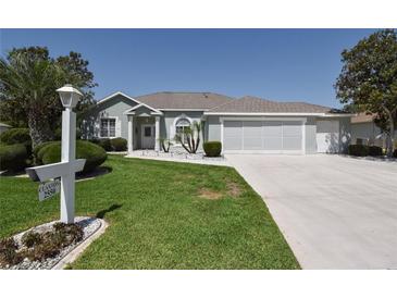 Charming single-story home with well-manicured lawn, mature trees and a spacious two car garage at 2550 Nw 55Th Avenue Rd, Ocala, FL 34482