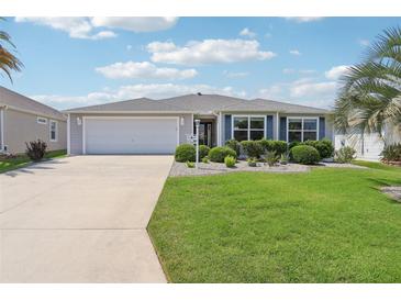Charming single-story home with a well-manicured lawn and a two-car garage at 3500 Countryside Path, The Villages, FL 32163