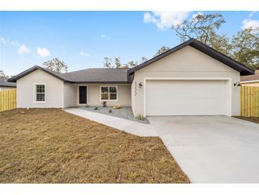 Charming single-story home featuring a two-car garage, fresh landscaping and a newly-paved driveway at 5389 Nw 65Th St, Ocala, FL 34482
