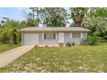 Charming single-story home with a well-manicured front yard and an attached garage at 8449 Sw 105Th Pl, Ocala, FL 34481