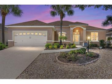 Charming single-story home with well-manicured landscaping, inviting entrance, and two-car garage at 9649 Sw 90Th St, Ocala, FL 34481
