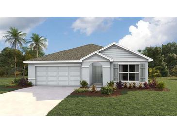 Charming single-story home featuring a two-car garage and a well-manicured lawn at 4235 Sw 53Rd Lane Rd, Ocala, FL 34474