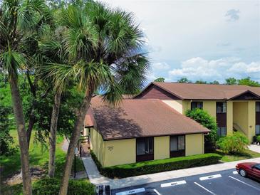 This cozy condo boasts lush landscaping, a convenient walkway, and ample parking, creating a welcoming and accessible exterior at 519 Fairways Cir # A, Ocala, FL 34472