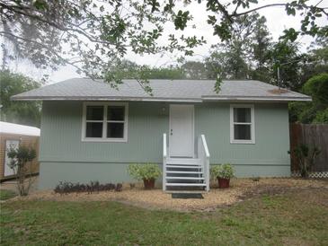 Charming single-story home featuring a landscaped front yard, inviting entrance, and neutral exterior color at 5949 Se 164Th Ct, Ocklawaha, FL 32179