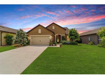 Charming single-story home with a well-manicured lawn, beautiful landscaping, and a two-car garage at 6868 Sw 95Th Cir, Ocala, FL 34481