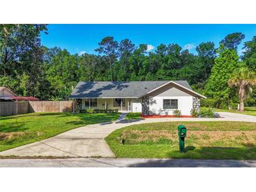 Charming single-story home featuring well-maintained lawn, stone accents and a long driveway at 2406 Se 40Th Street Rd, Ocala, FL 34480