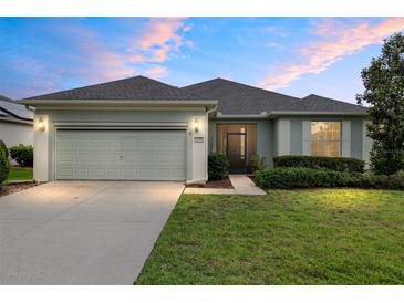 Charming one-story home with well-manicured lawn and a two-car garage at 6651 Sw 93Rd Ct, Ocala, FL 34481