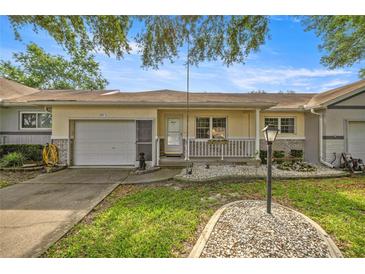 Charming single story home features a front porch, attached garage, and well maintained landscaping at 9667 Sw 94Th Ct # C, Ocala, FL 34481