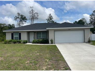 Charming single-story home features a well-manicured lawn and a two-car garage at 3338 Sw 165Th Loop, Ocala, FL 34473