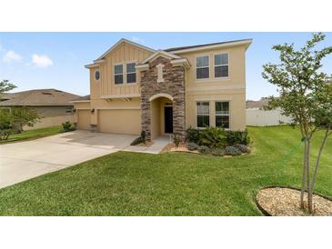 Charming two-story home featuring a stone-accented entrance and well-manicured front yard at 5653 Sw 50Th Ter, Ocala, FL 34474