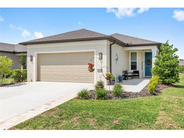 Charming single-story home featuring a well-manicured lawn and two-car garage at 8820 Sw 58Th Street Rd, Ocala, FL 34481