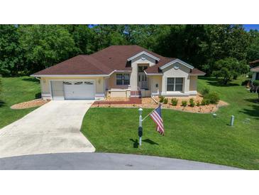 Charming single-story home with well-manicured lawn and attached two-car garage at 11586 Sw 75Th Cir, Ocala, FL 34476