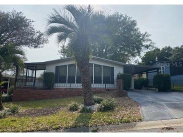 Charming single-story home with a well-maintained lawn and mature landscaping at 1408 Torrey Pines Dr, Lady Lake, FL 32159