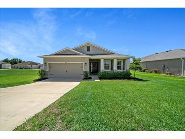 Charming single-story home featuring a well-manicured lawn and attached two-car garage at 8870 Sw 62Nd Ave, Ocala, FL 34476