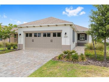 Charming single-story home featuring a two-car garage, well-maintained landscaping, and a welcoming entrance at 10427 Sw 98Th Place Rd, Ocala, FL 34481