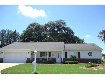 Charming single-story home boasts a well-manicured lawn and welcoming front porch at 13762 Sw 112Th Ter, Dunnellon, FL 34432