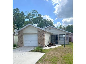 Charming single-story home with a brick-accented garage and well-manicured lawn at 2209 Ne 40Th Ave, Ocala, FL 34470