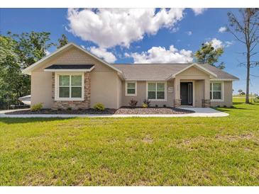 Charming single-story home with stone accents, manicured lawn, and inviting curb appeal under a bright sky at 2525 Sw 7Th Ave, Ocala, FL 34471