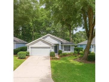 Charming single-story home featuring a manicured lawn and an attached two-car garage at 8926 Sw 192Nd Court Rd, Dunnellon, FL 34432