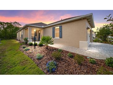 Charming one-story home with a beautifully landscaped front yard and covered entryway, creating a welcoming curb appeal at 9309 Sw 106Th Ave, Ocala, FL 34481