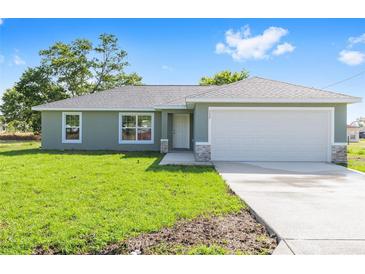 Charming single-story home with a well-manicured lawn and two-car garage at 10121 Sw 130Th Ter, Dunnellon, FL 34432