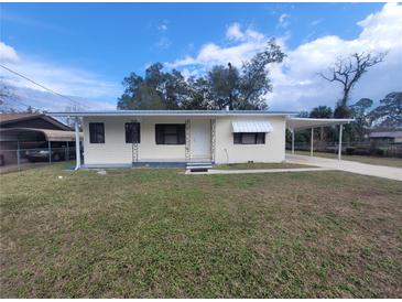 Charming single-story home featuring a covered carport and front yard at 2215 Ne 16Th Ct, Ocala, FL 34470