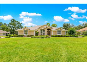 Charming single-story home with well-manicured lawn and mature landscaping at 28 Golf View Dr, Ocala, FL 34472