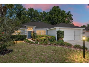 Charming single-story home featuring well-maintained landscaping, a two-car garage, and a welcoming front entrance at 8053 Sw 62Nd Ave, Ocala, FL 34476