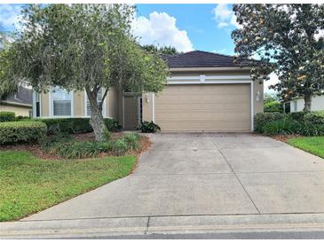 Charming single-story home with a well-manicured lawn, a two-car garage, and mature trees at 2515 Se 19Th Cir, Ocala, FL 34471