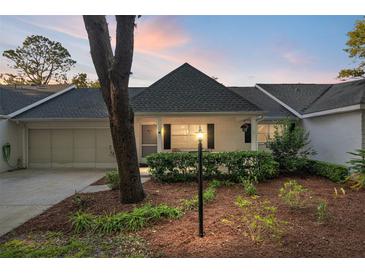 Charming single story home with a well-manicured front yard and welcoming entrance at sunset at 8681 Sw 93Rd Pl # B, Ocala, FL 34481