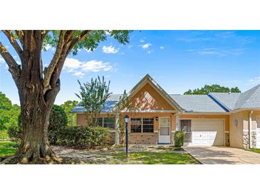 Charming single-story villa with well-maintained landscaping and attached one-car garage at 9330 Sw 84Th Ter # A, Ocala, FL 34481