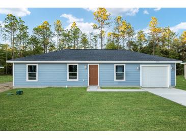 Single-story home with a front yard and attached garage at 315 Sw 140 Ave, Ocala, FL 34481