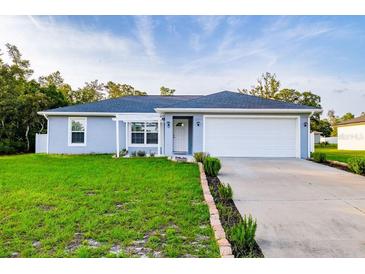 Charming single-story home featuring well-manicured lawn, two car garage, and inviting front entrance at 3897 Sw 169Th Lane Rd, Ocala, FL 34473